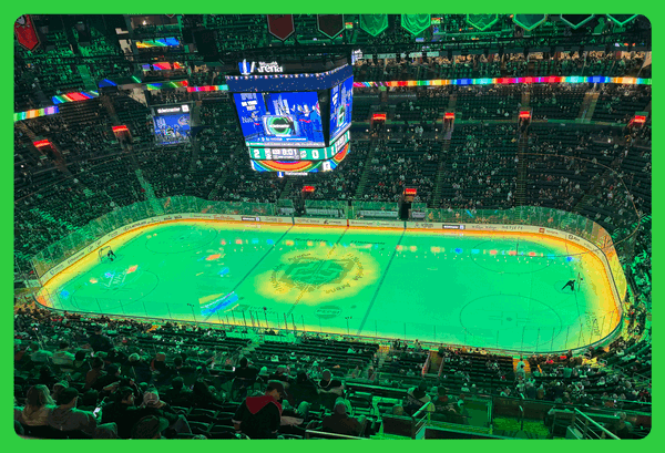 Nationwide Arena is bathed in green light on St. Patrick's Day. The ice looks like frozen green beer.